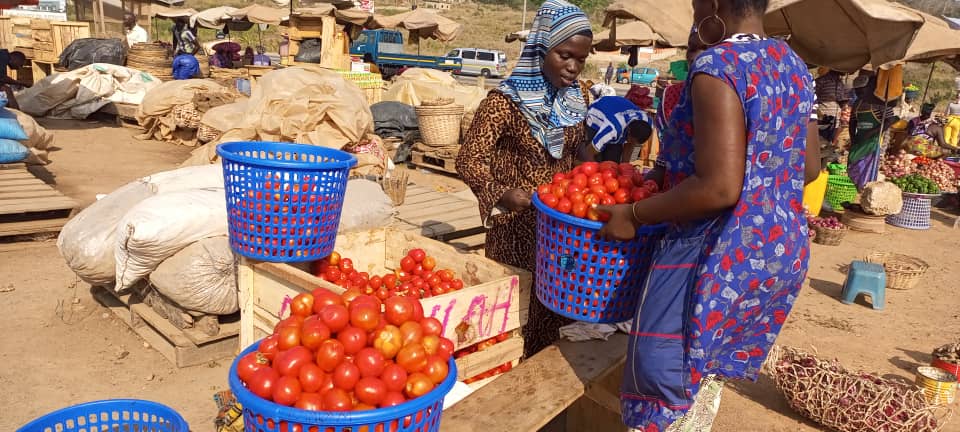 Fresh produce at a busy agricultural market